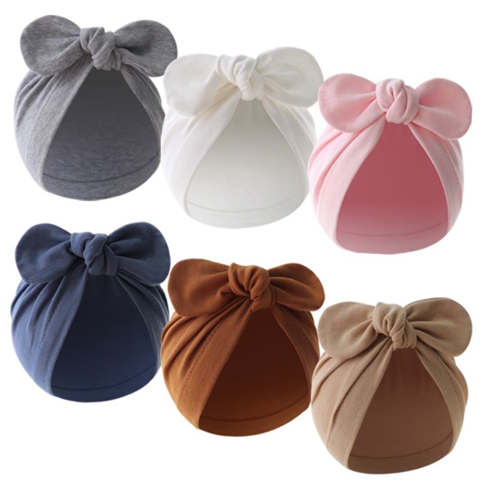 Infant Beanie Hat With Ears - หมวกเด็กทารกผูกโบว์ลายดอกไม้น่ารัก สีพื้น หมวกหูกระต่ายนุ่ม ผ้าฝ้าย หมวกบีนนี่เด็กเล็ก หมวกเด็กวัยหัดเดิน